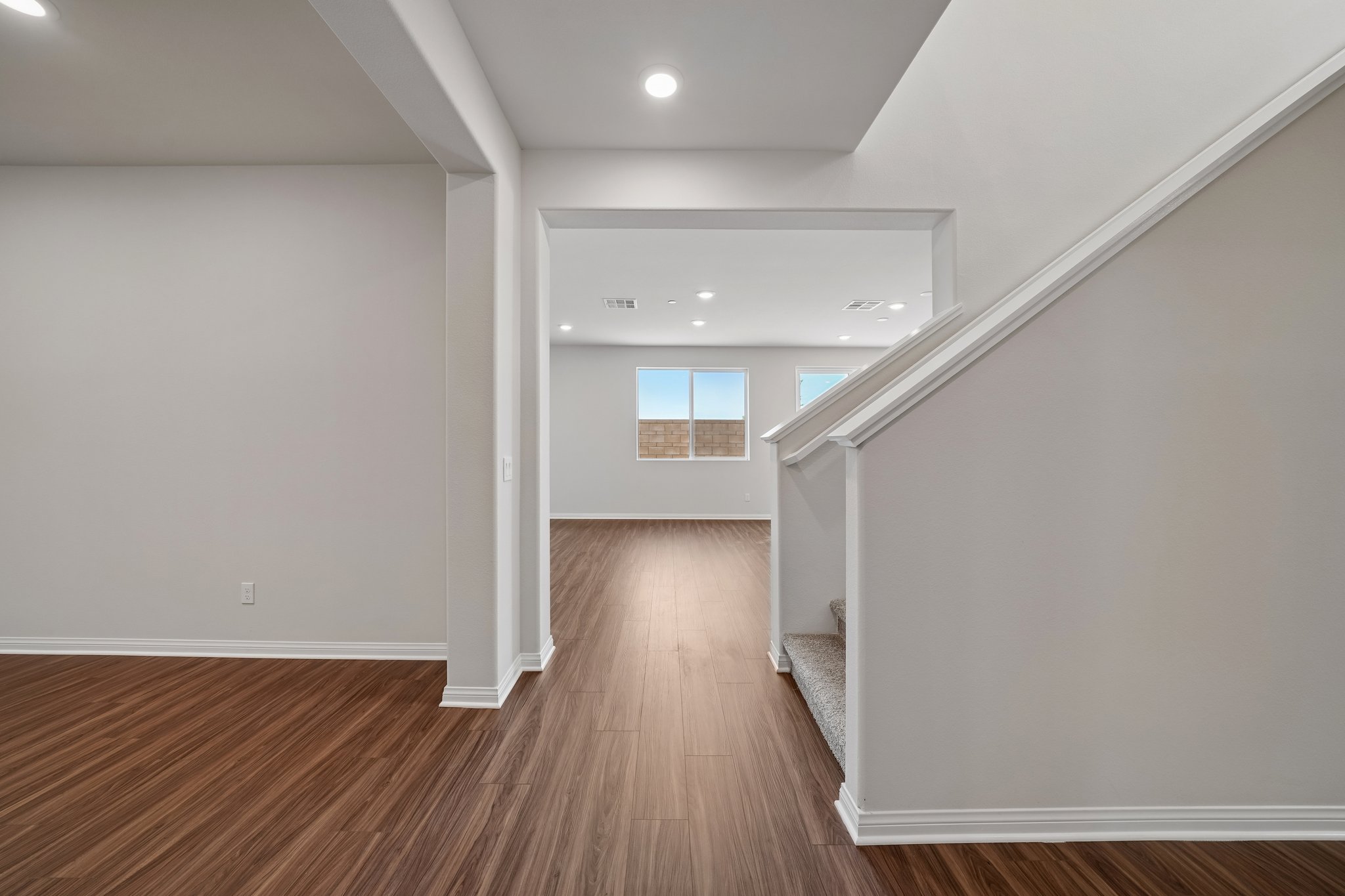 A room with a wood floor and white walls.