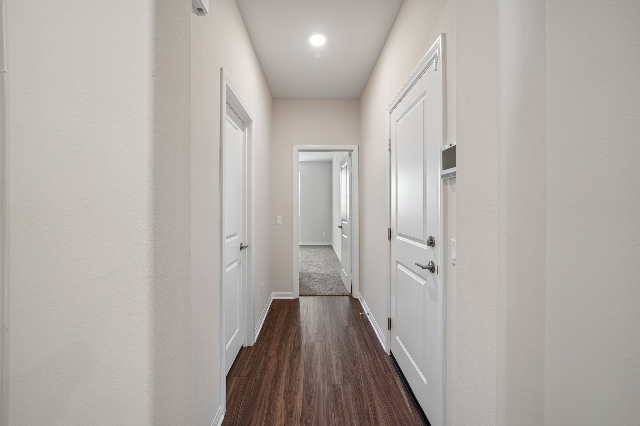 A hallway with white doors.
