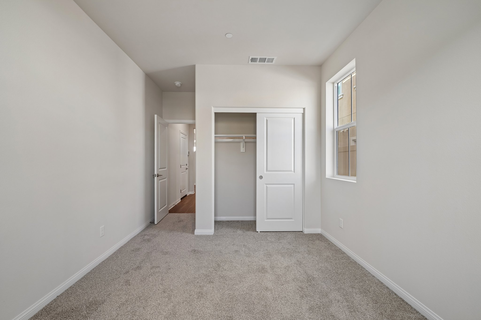 A hallway with white doors.