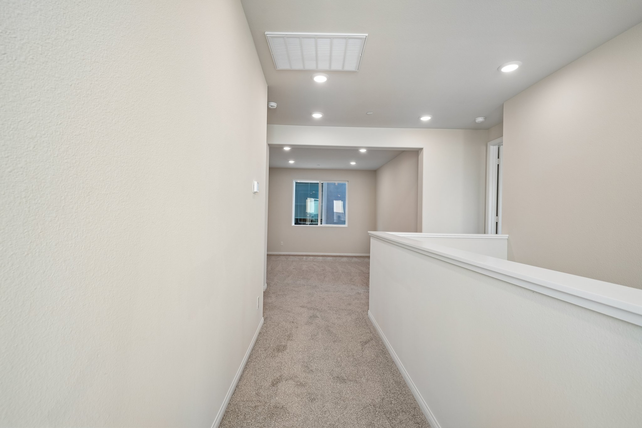 A long hallway with a window.