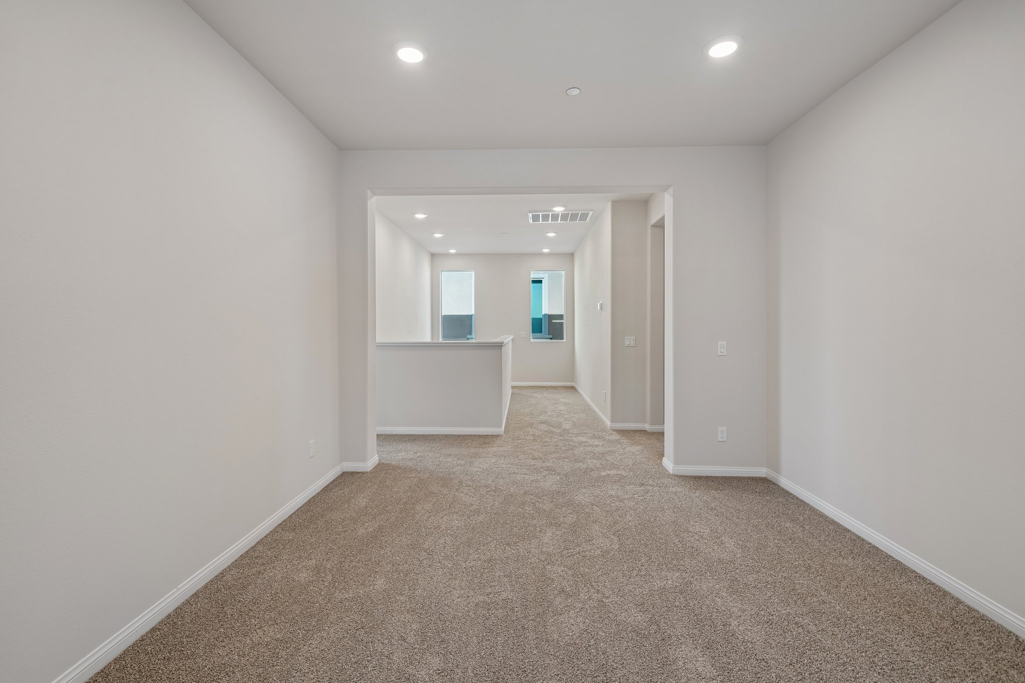 A hallway with white walls.