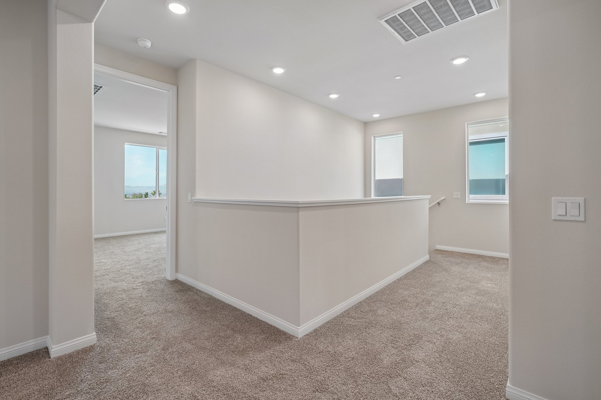 A room with a large white bed.