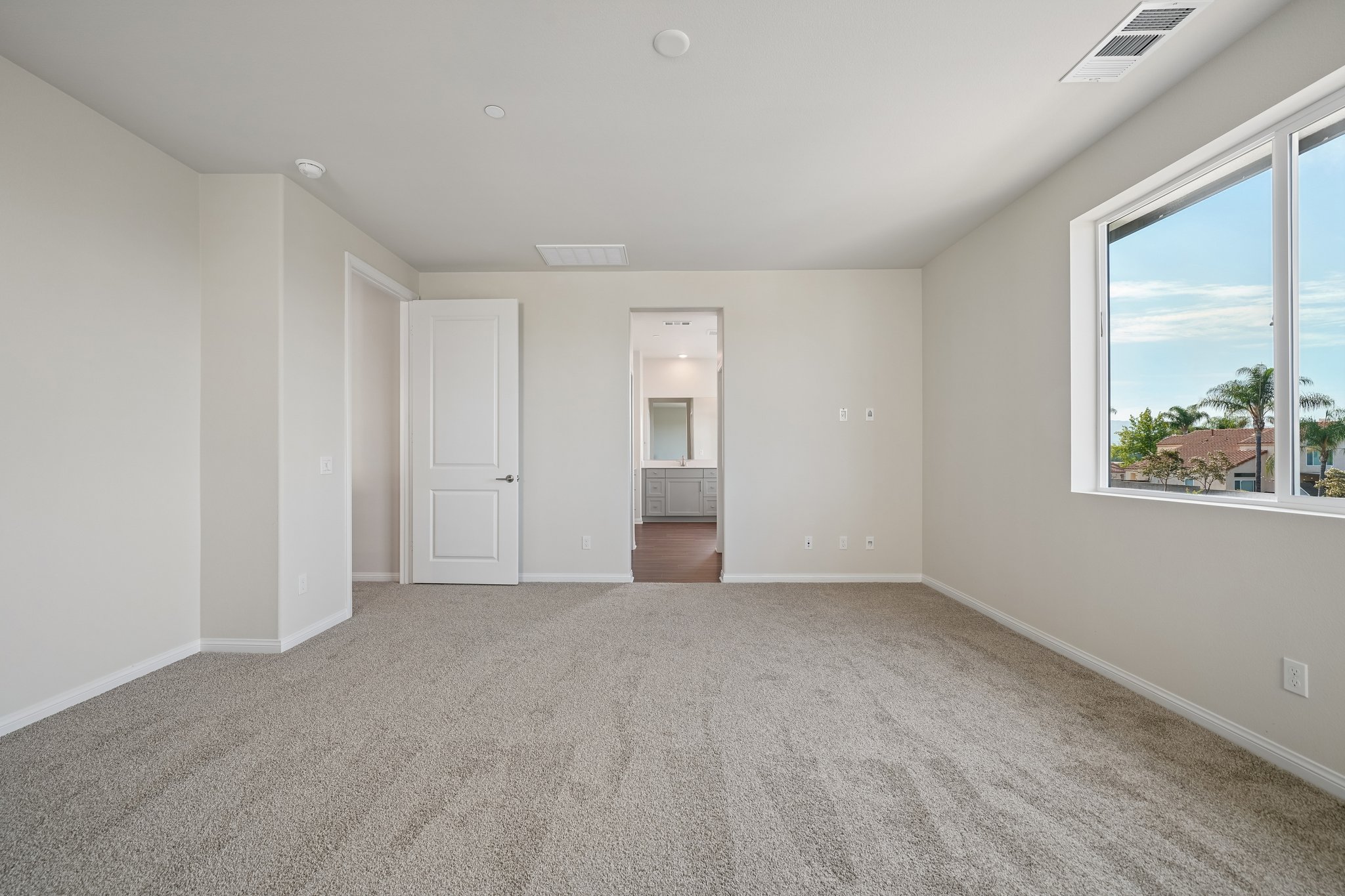 A room with a window and a door.