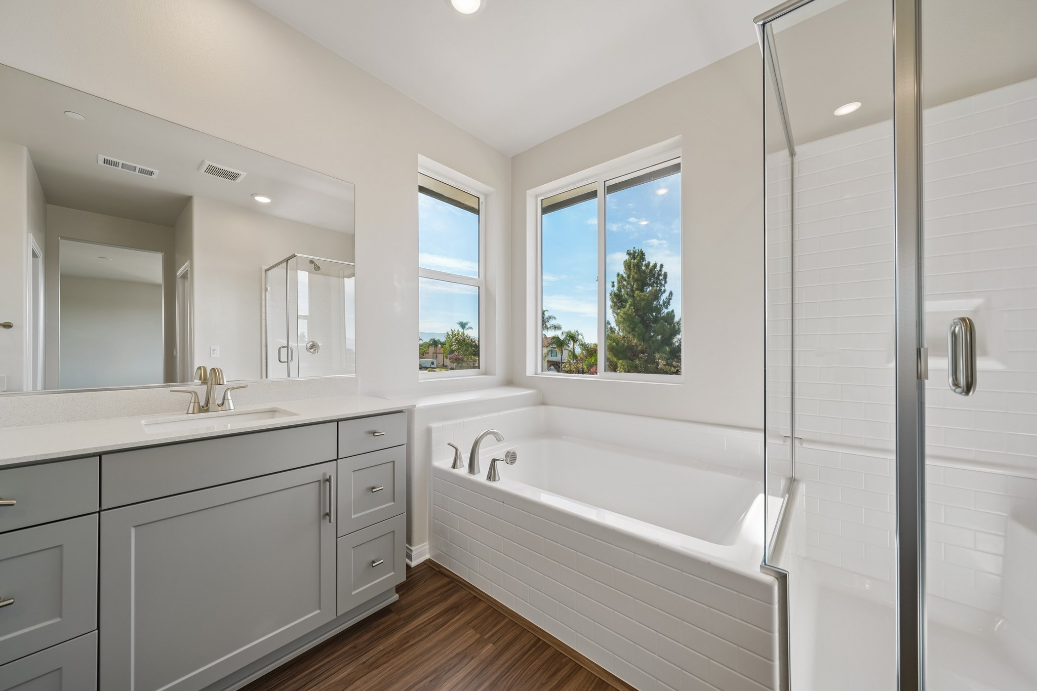 A bathroom with a tub sink and a shower.