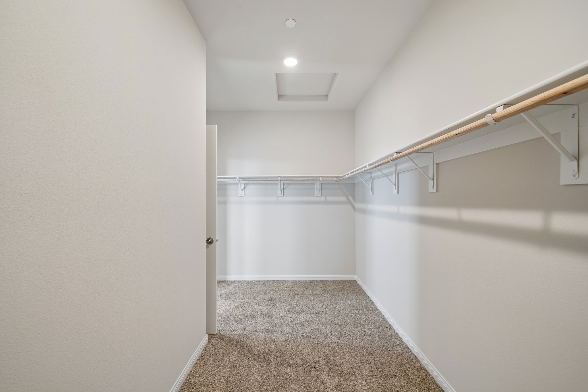 A hallway with white walls.