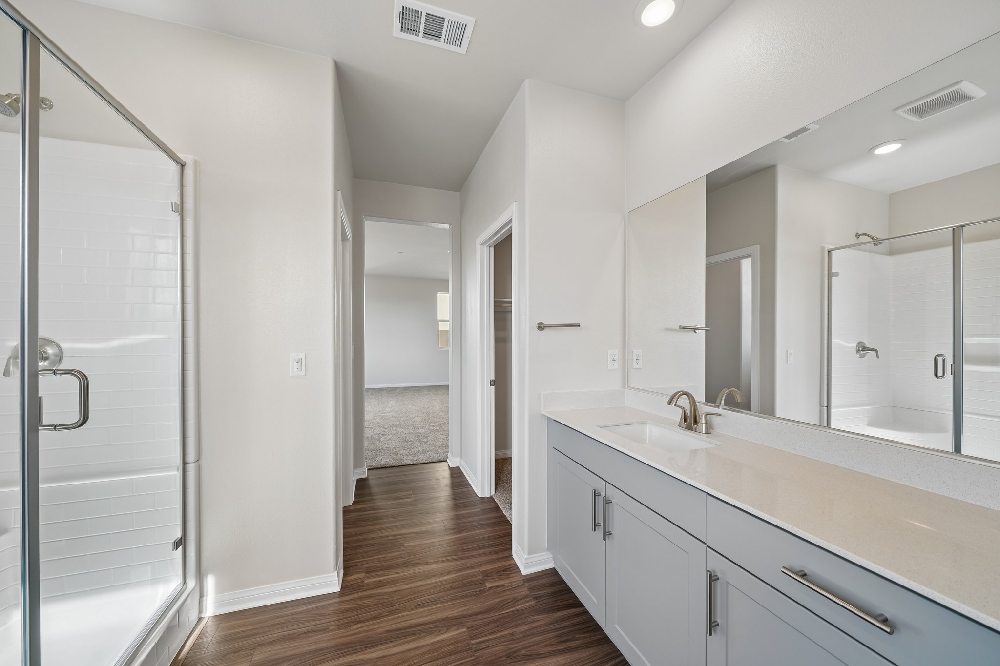 A bathroom with a large mirror.