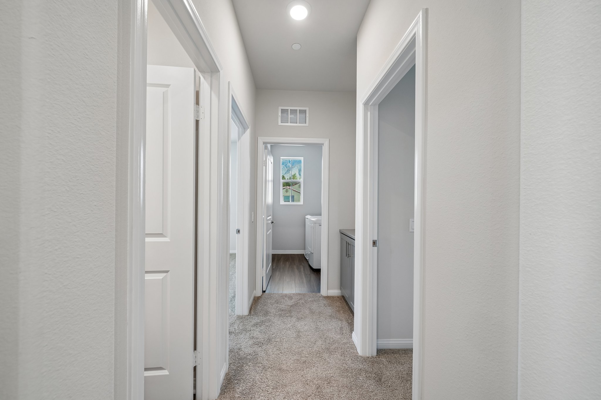 A hallway with white doors.