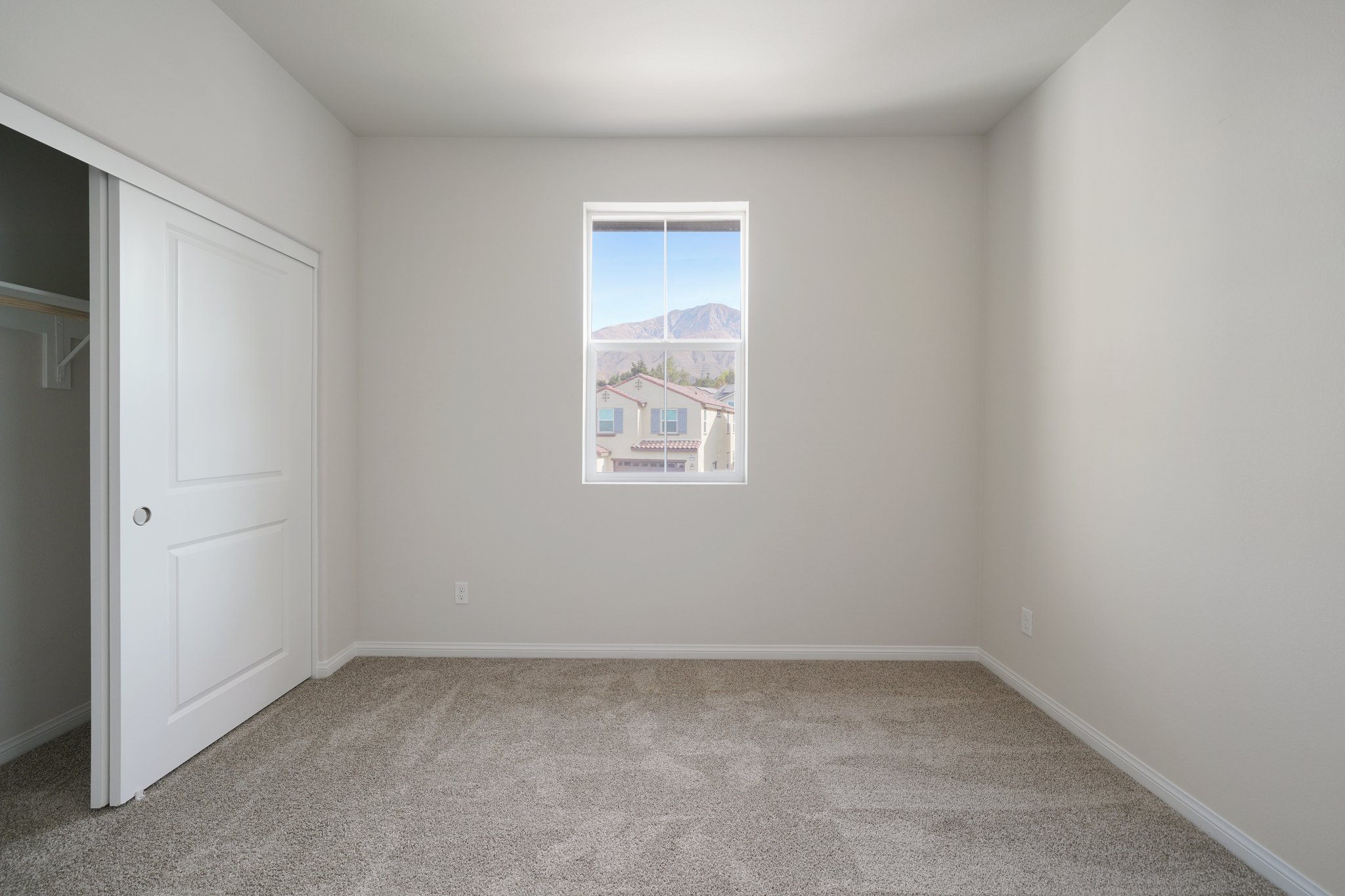 A room with a window and a door.