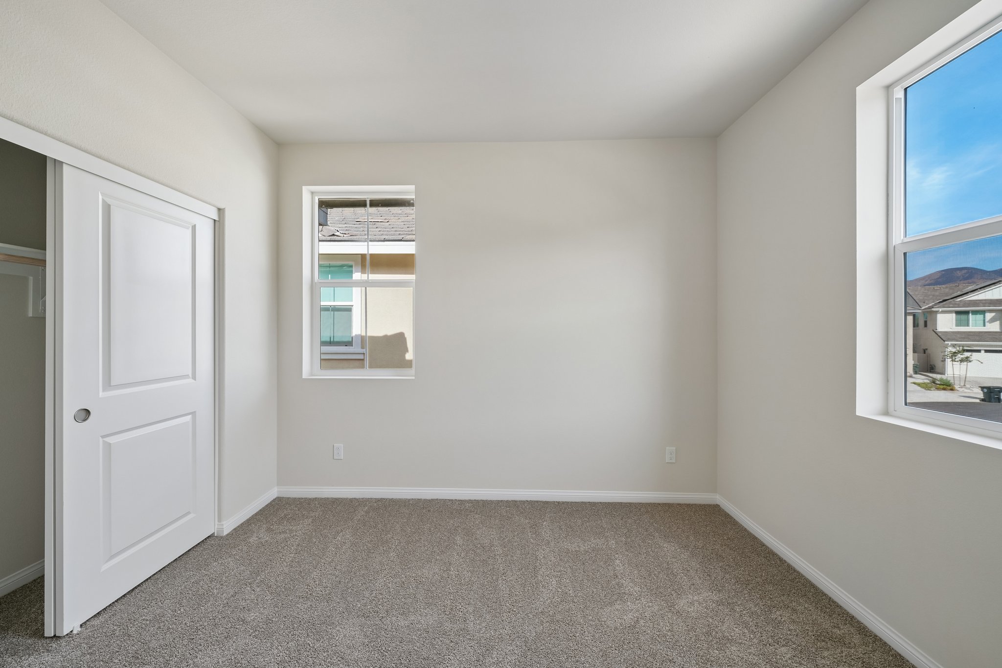 A room with a door and windows.