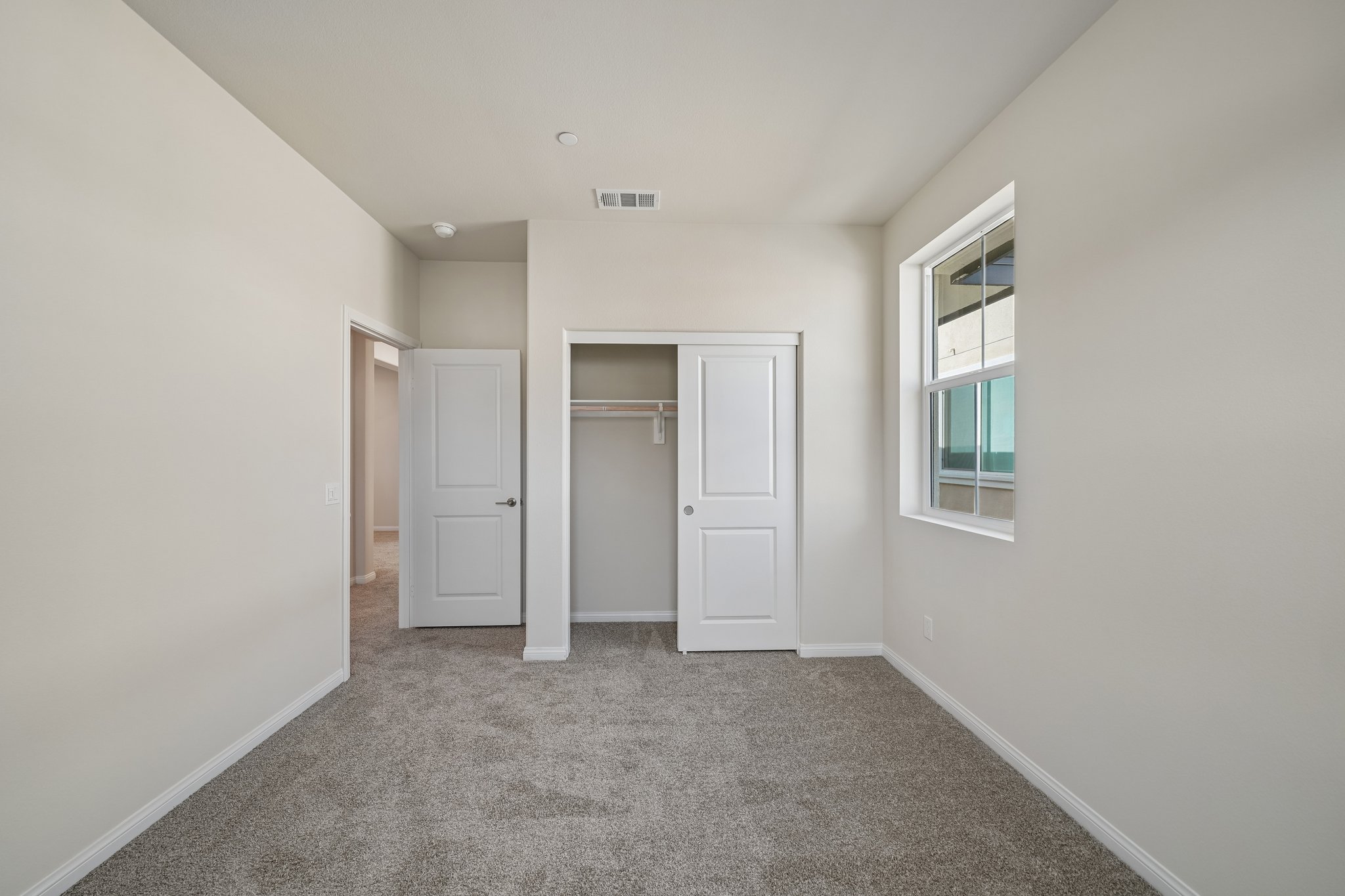 A hallway with white doors.