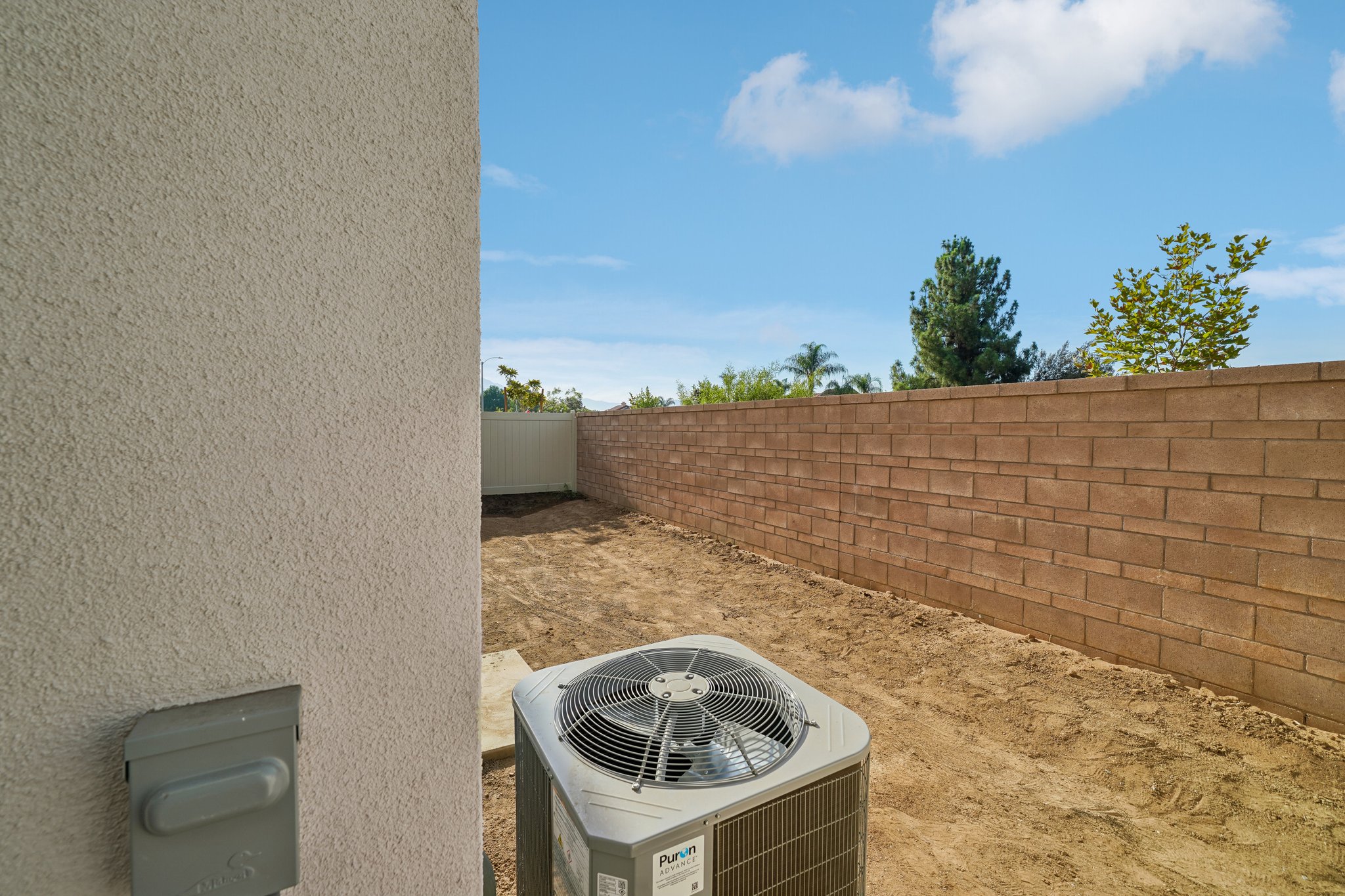 A brick wall with a brick wall and a metal radiator.