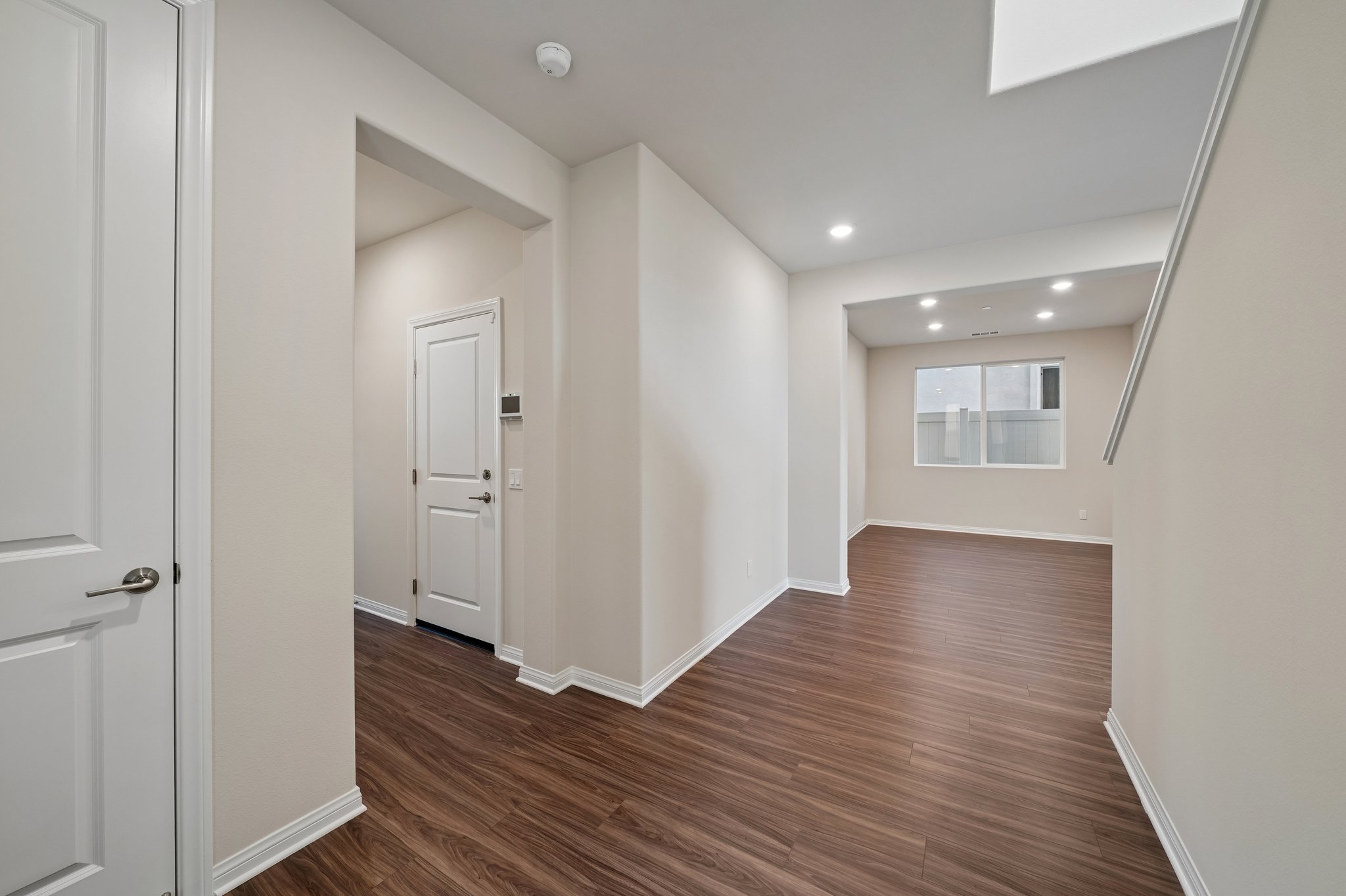 A room with white walls and wood floors.