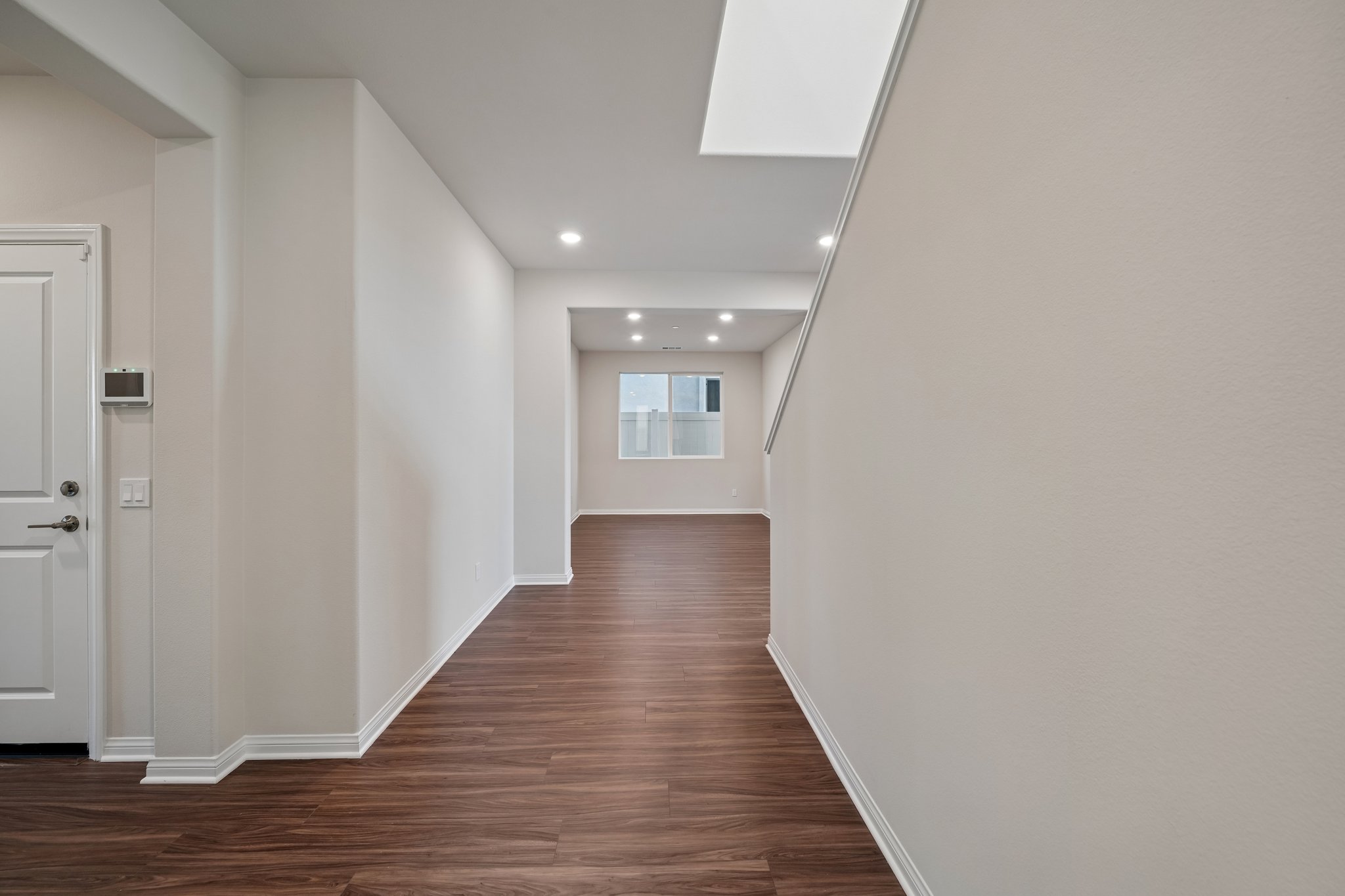 A hallway with white walls.