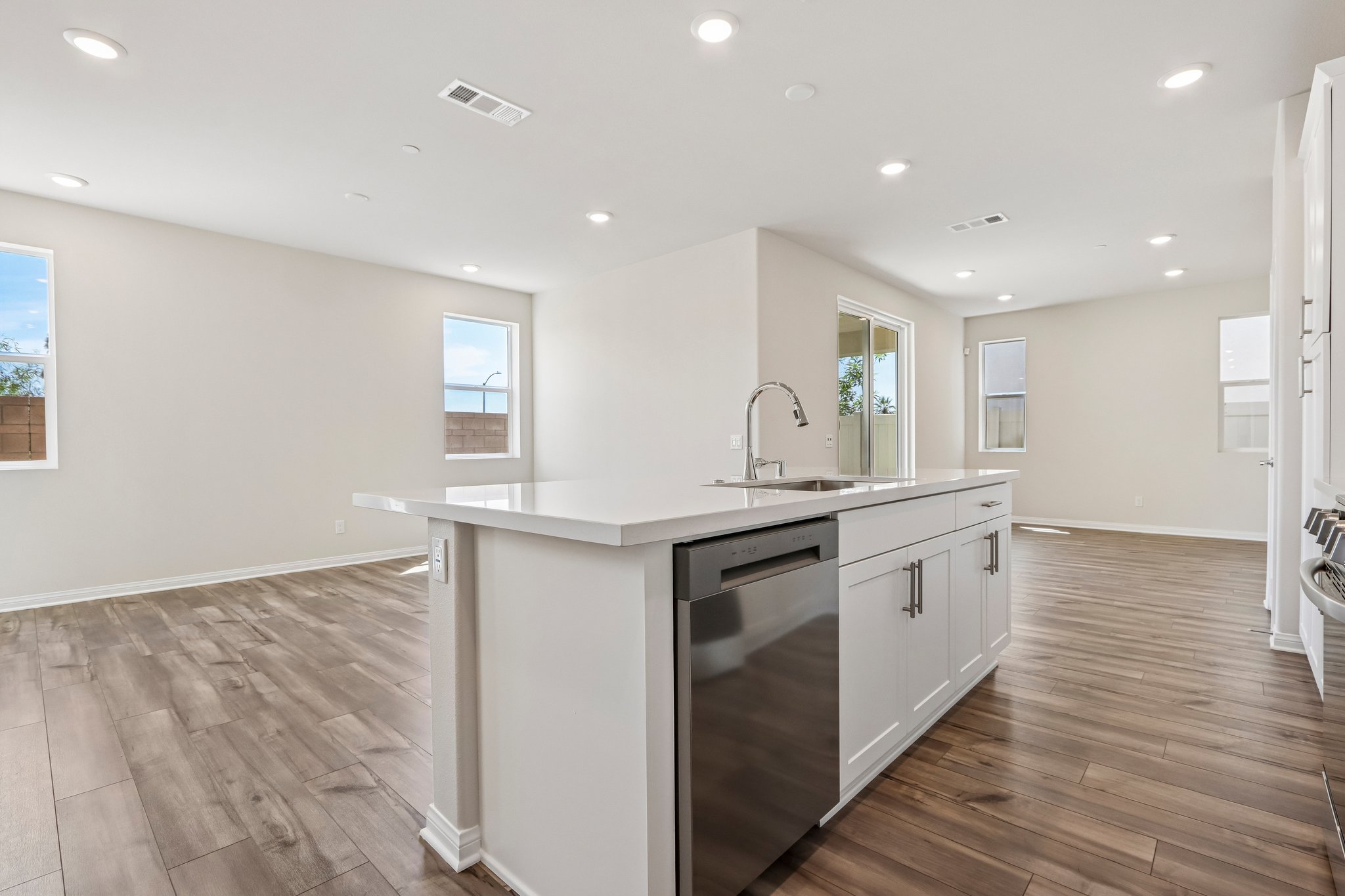 A kitchen with white cabinets.