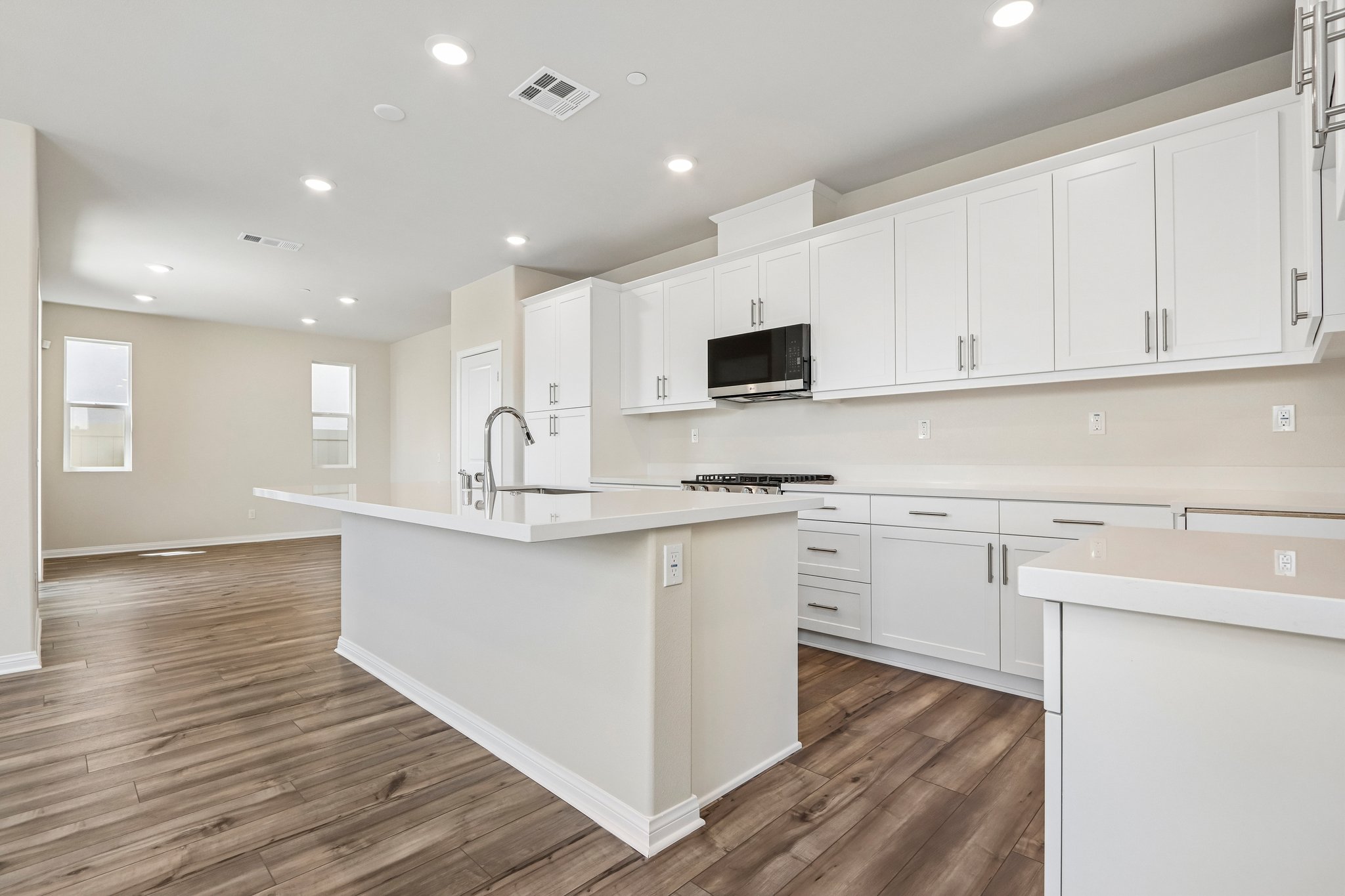 A kitchen with white cabinets.