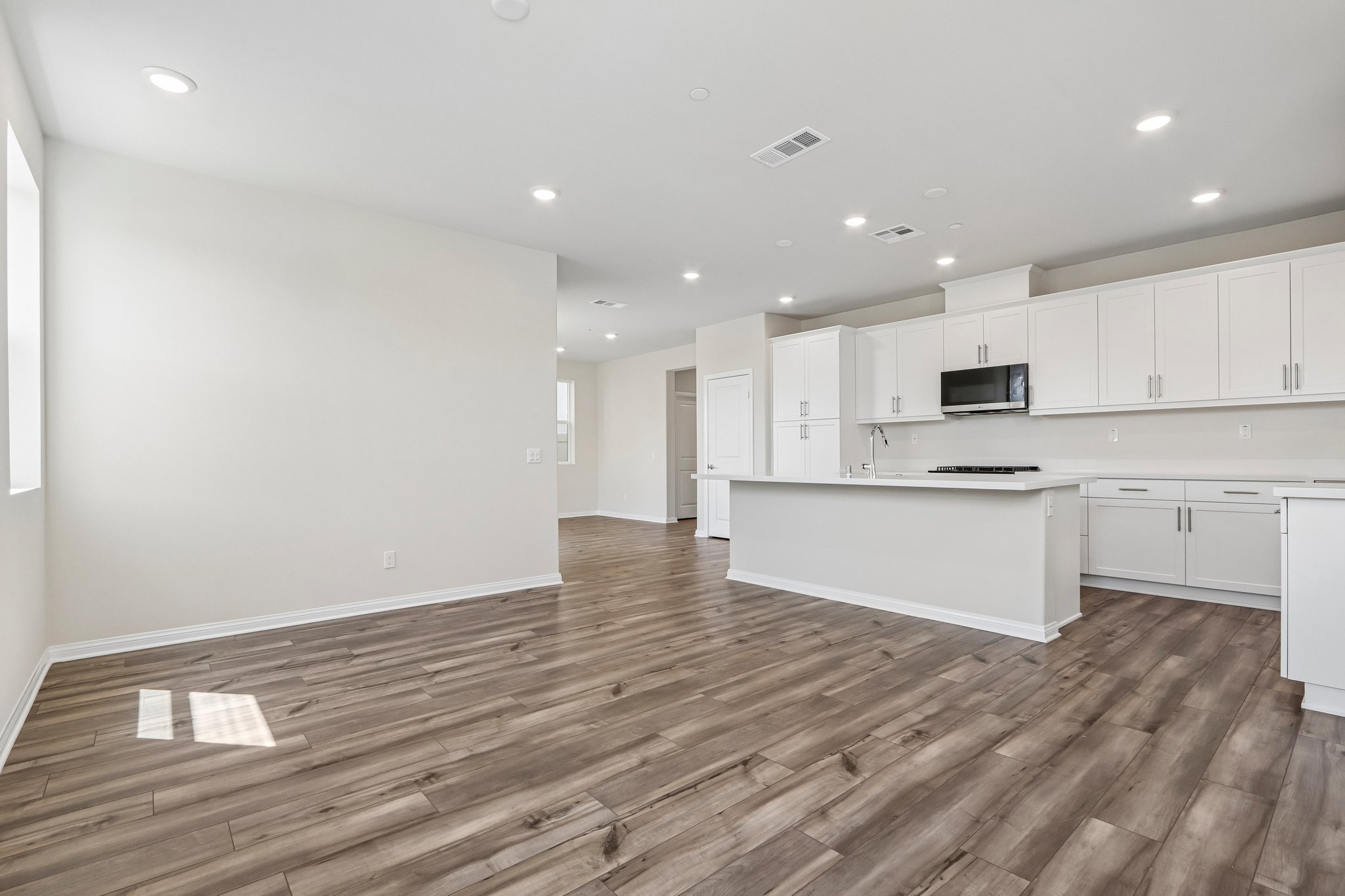 A large kitchen with white cabinets.
