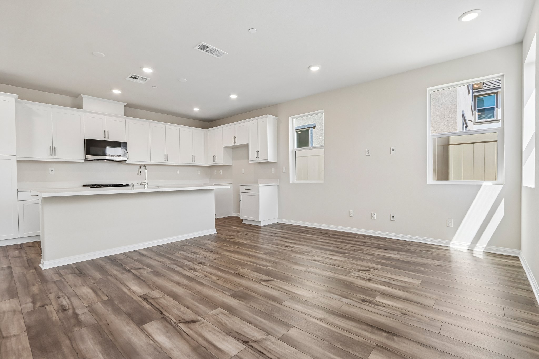 A kitchen with white cabinets.