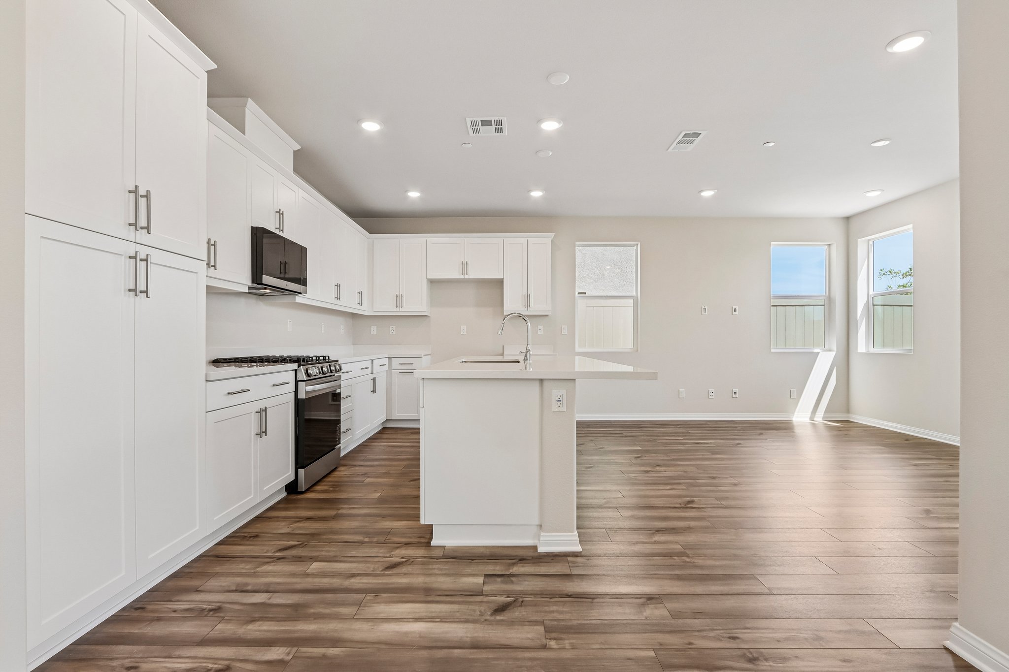 A kitchen with white cabinets.