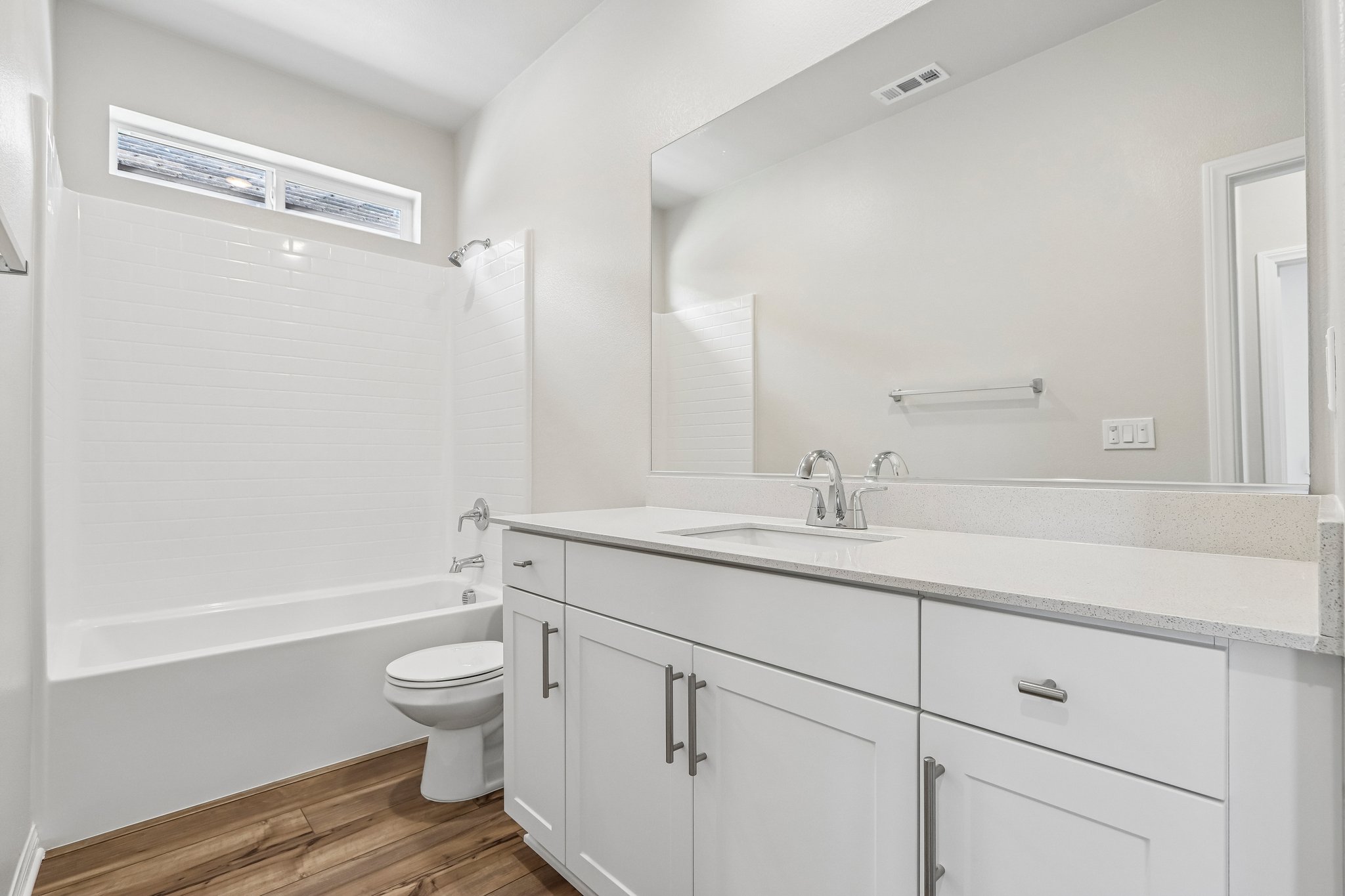 A bathroom with a tub toilet and sink.