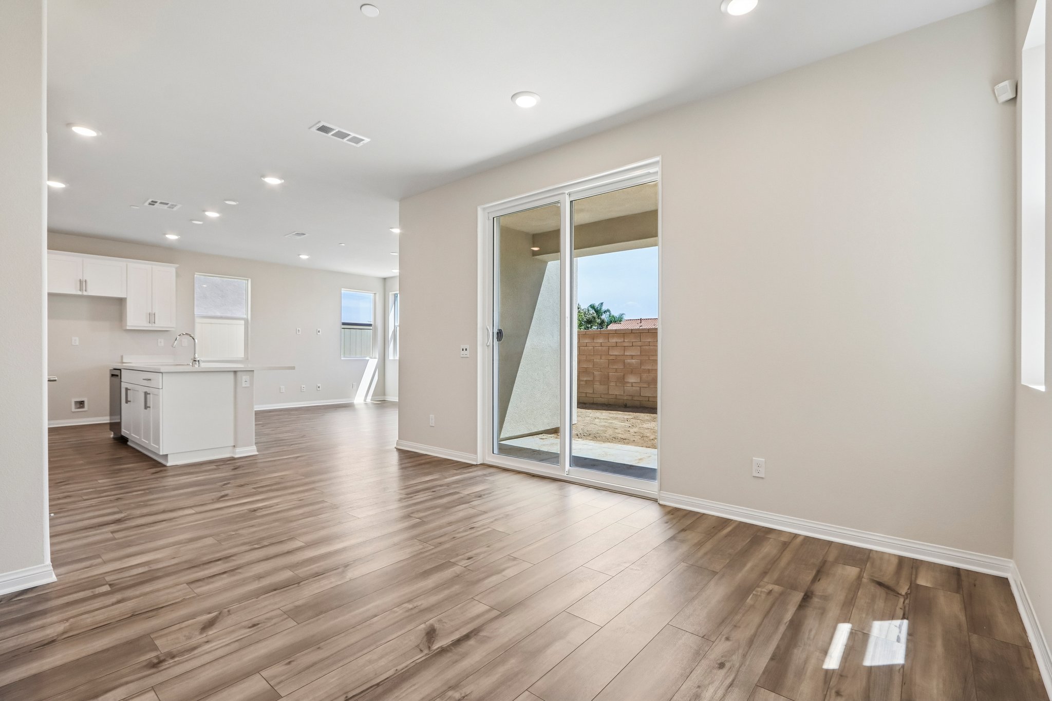 A room with a wood floor and a glass door.