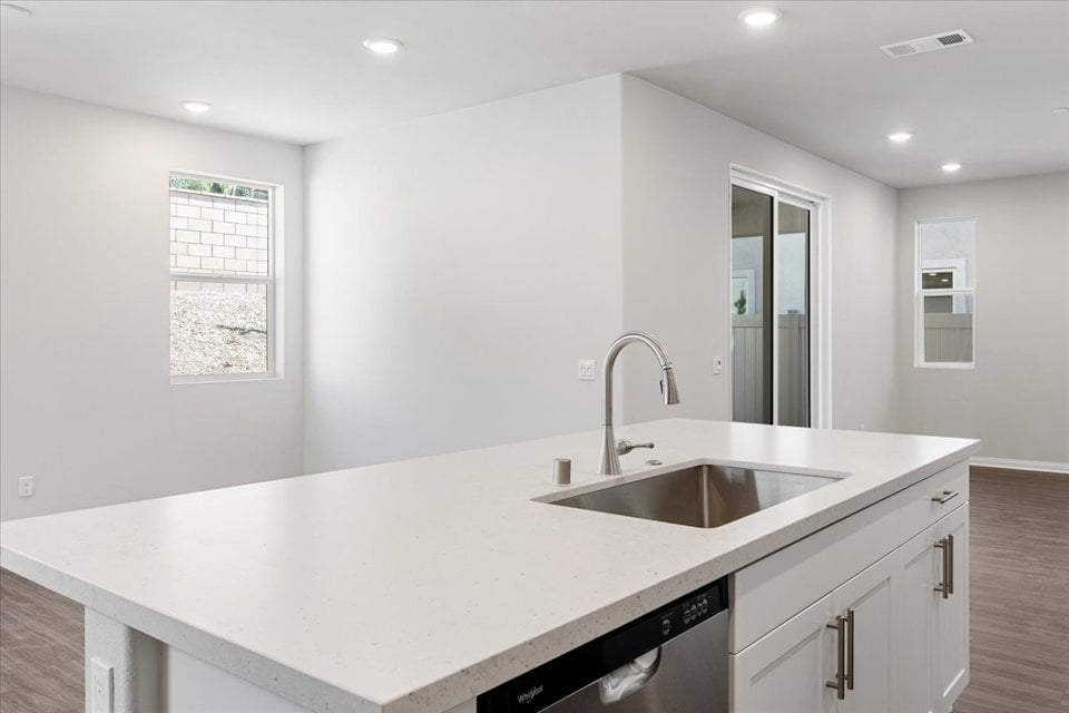 A kitchen with a marble countertop.