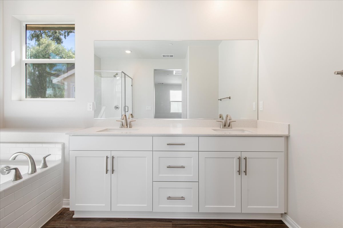 A bathroom with white cabinets.