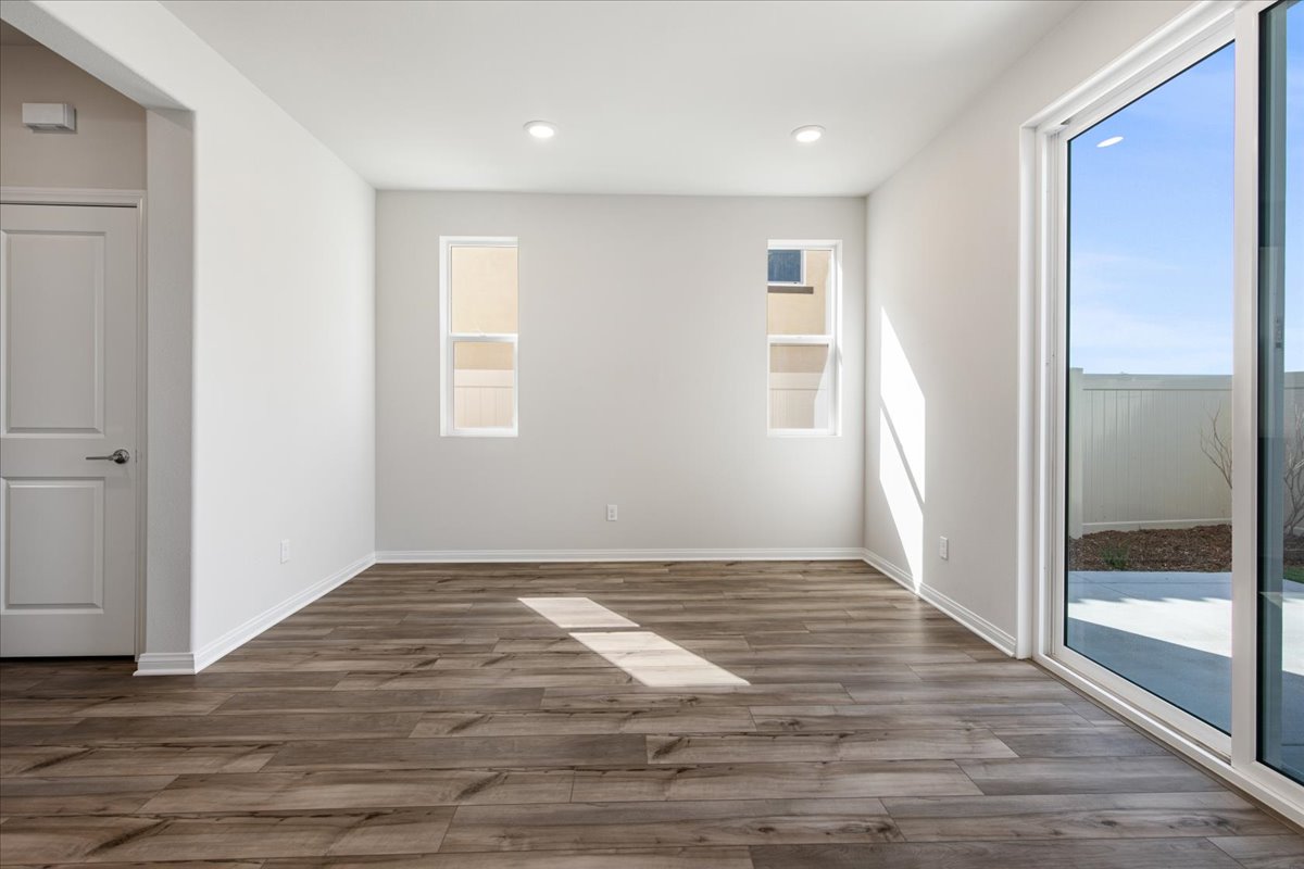 A room with a wood floor and a glass door.