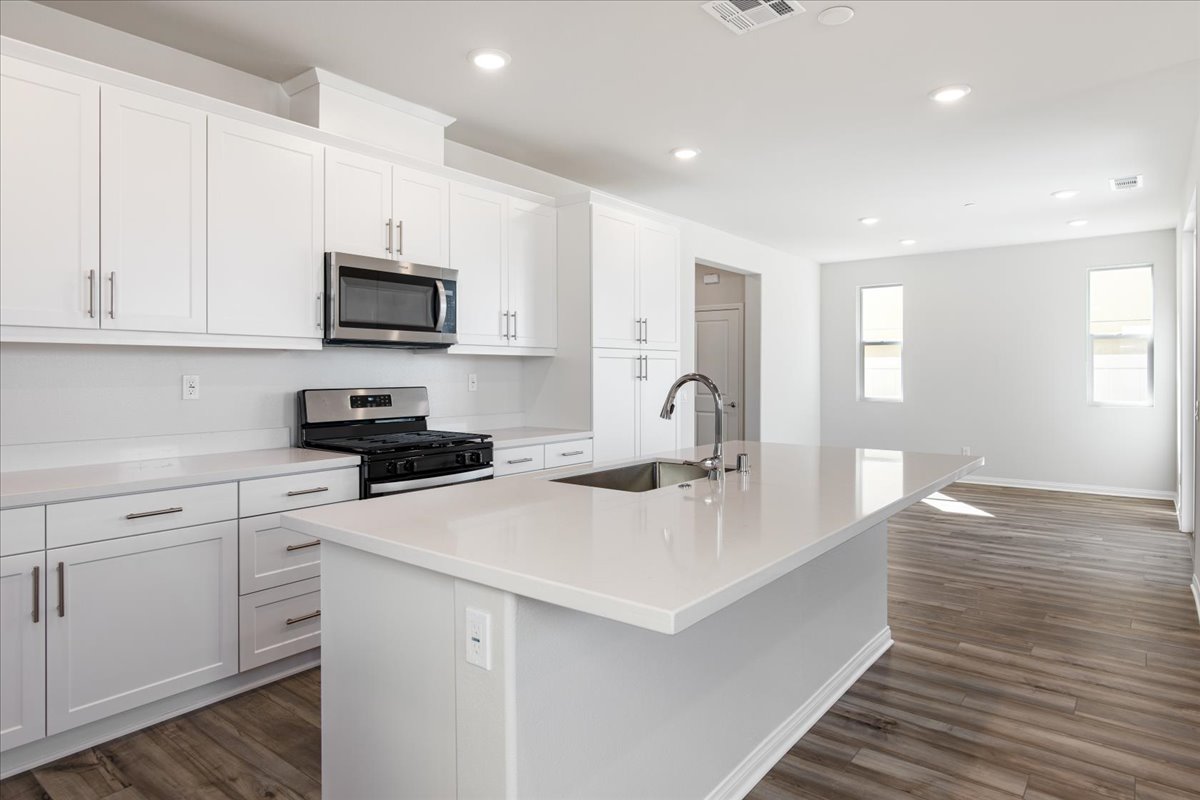 A kitchen with white cabinets.