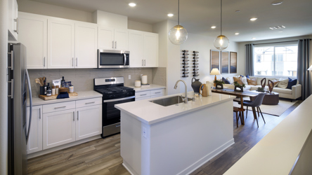 A kitchen with white cabinets.