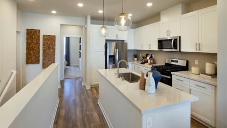 A kitchen with white cabinets.