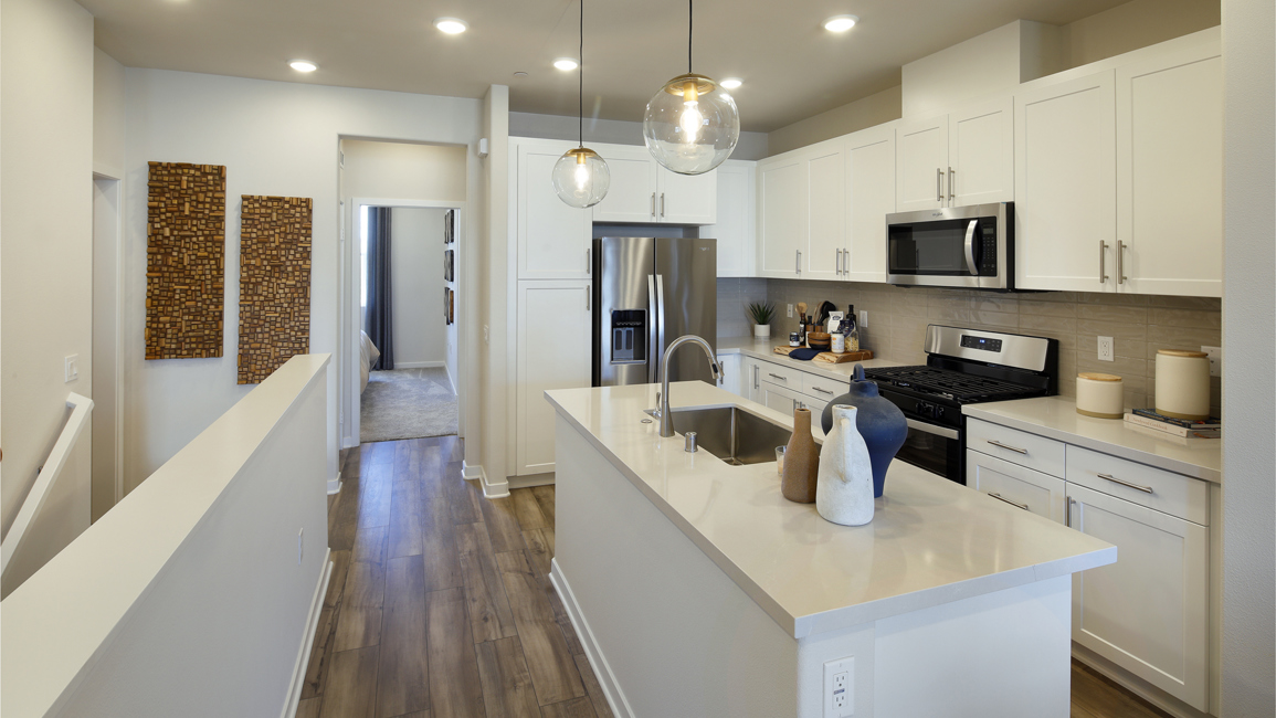A kitchen with white cabinets.