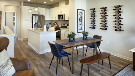 A kitchen with a dining table.