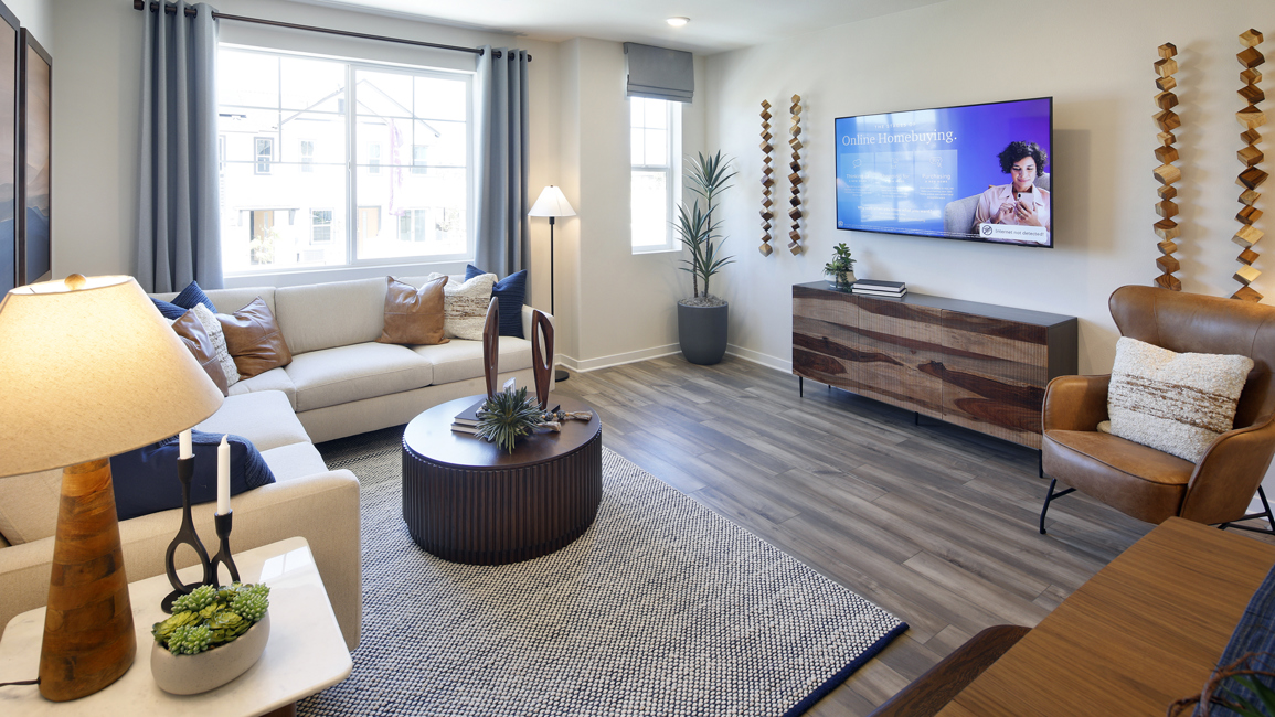 A living room with a rug and a tv.
