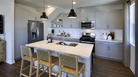 A kitchen with a table and chairs.