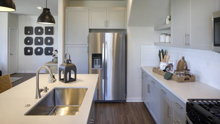 A kitchen with white cabinets.