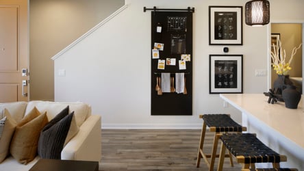 A room with a couch and a table with a chair and a table.