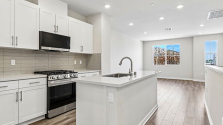 A kitchen with white cabinets.