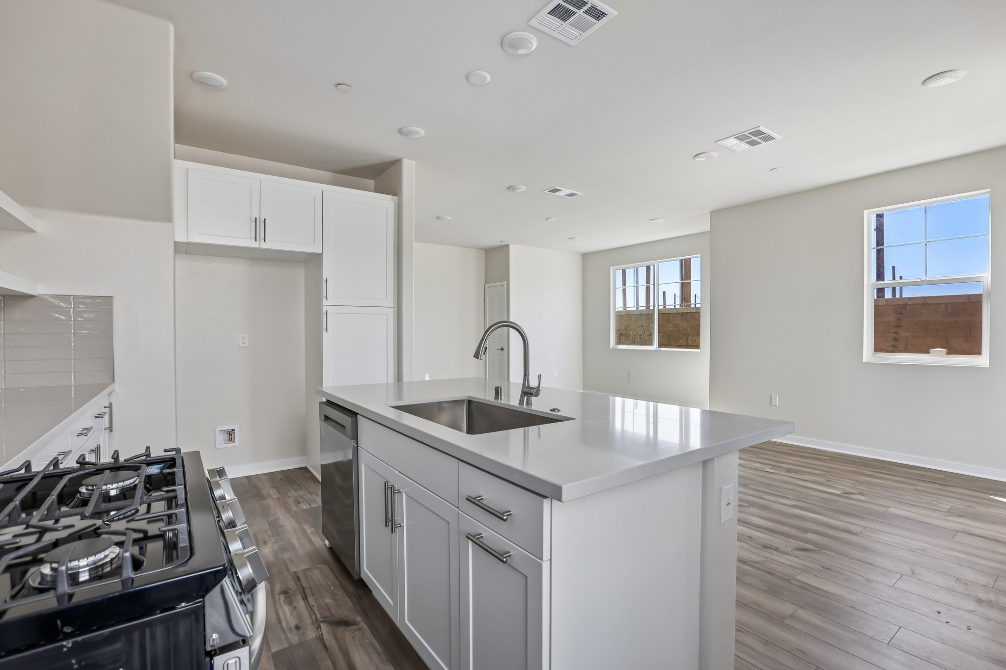 A kitchen with white cabinets.