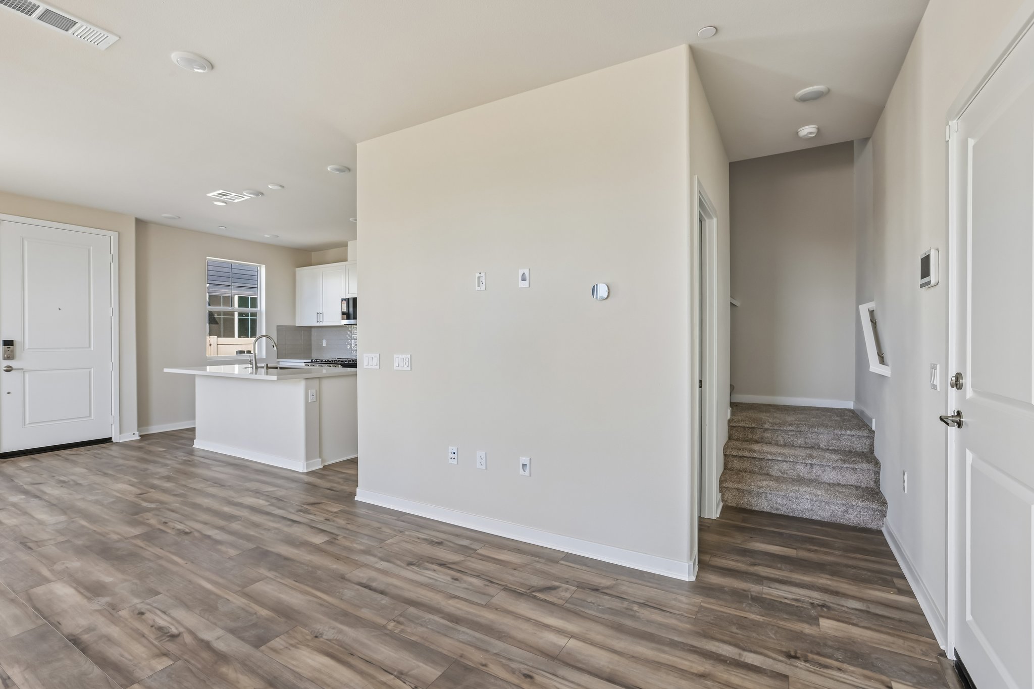 A room with a wood floor and white walls.