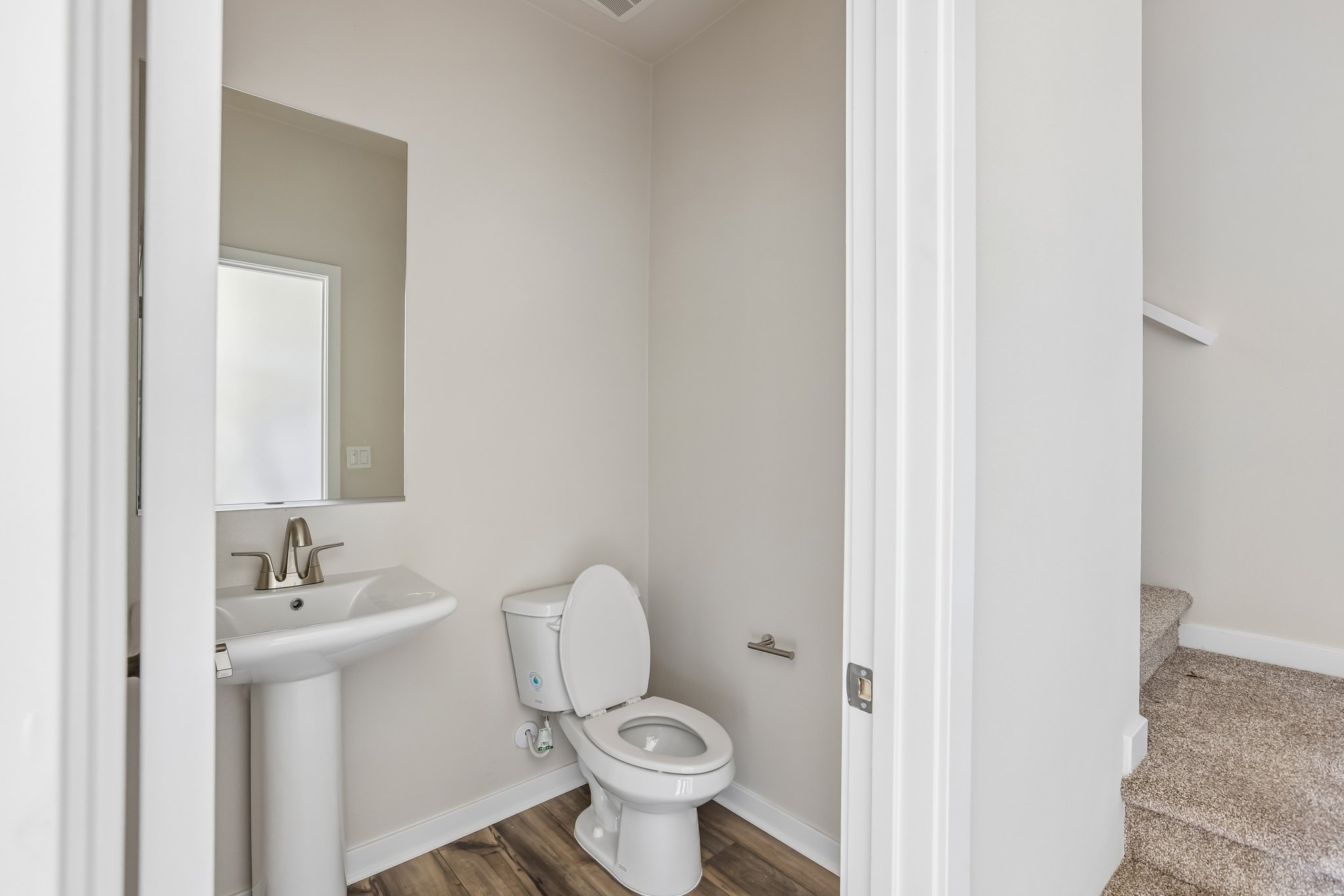 A bathroom with a toilet and sink.