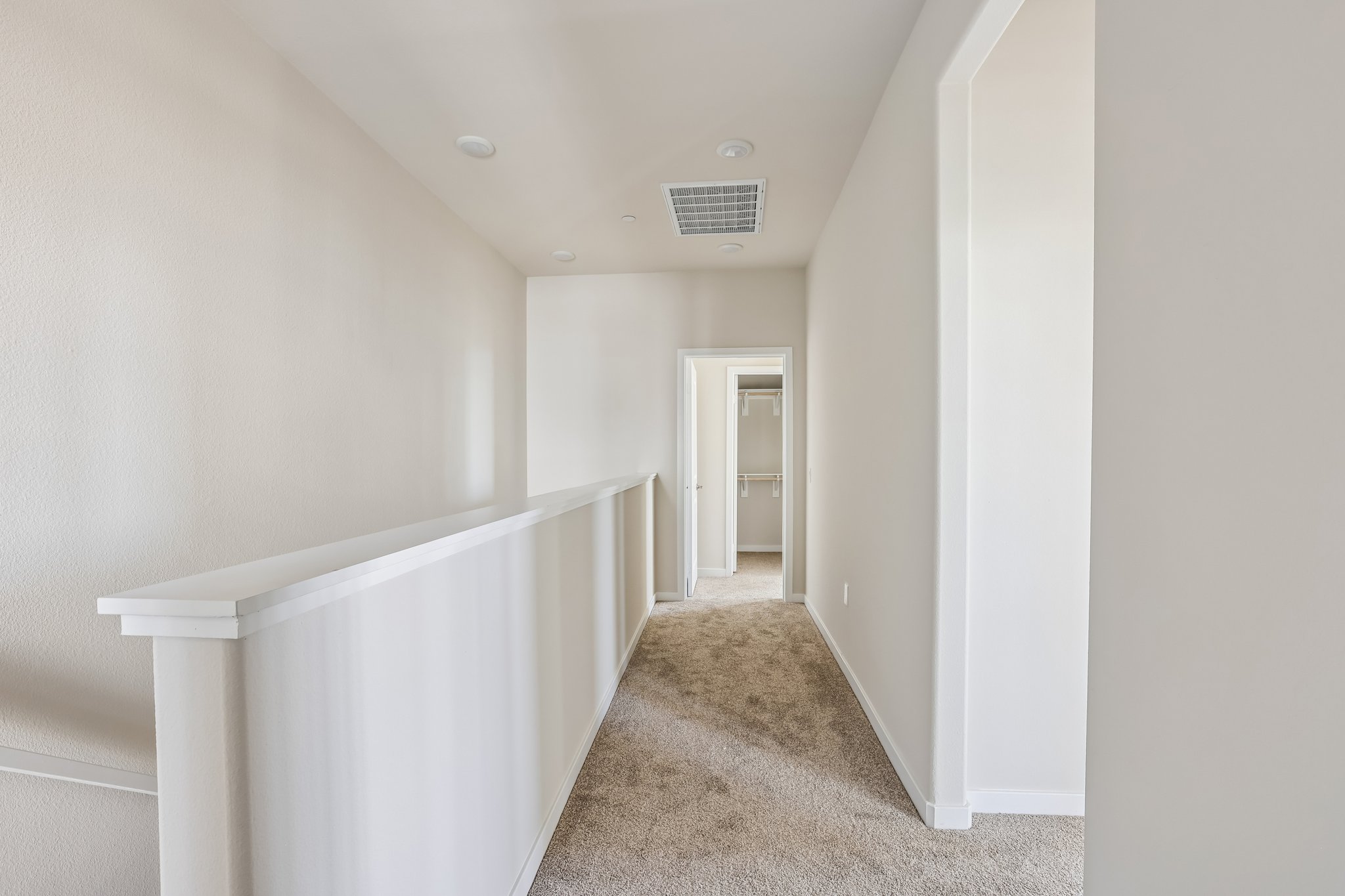 A hallway with white walls.
