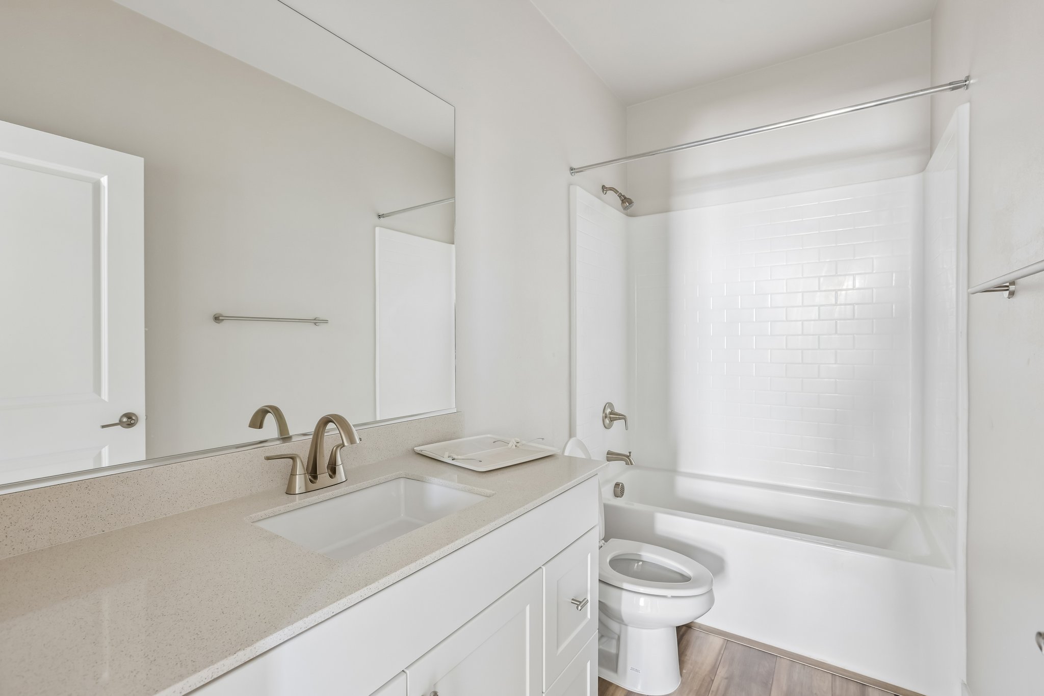 A bathroom with a sink toilet and bathtub.
