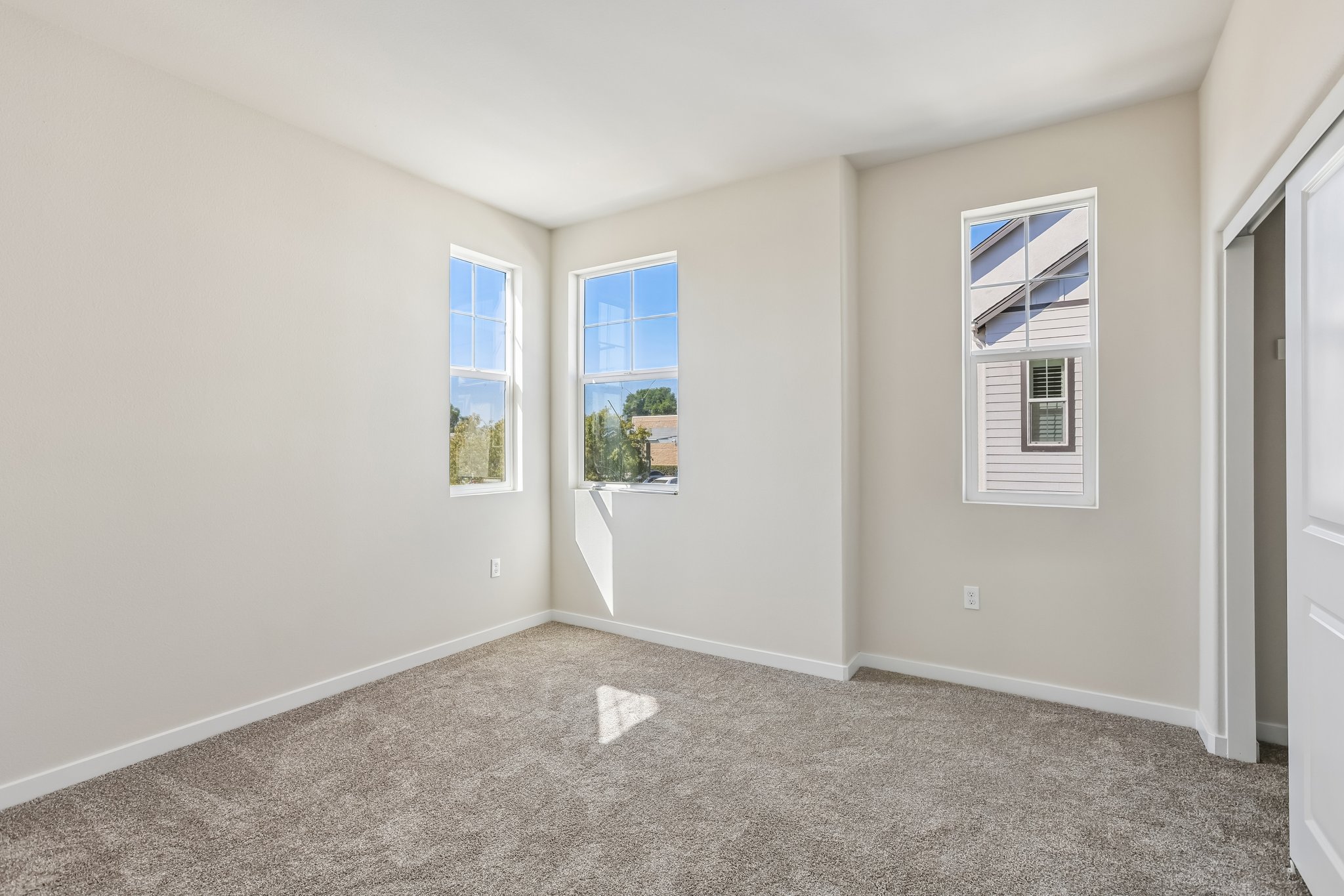 A room with a carpet and a window.