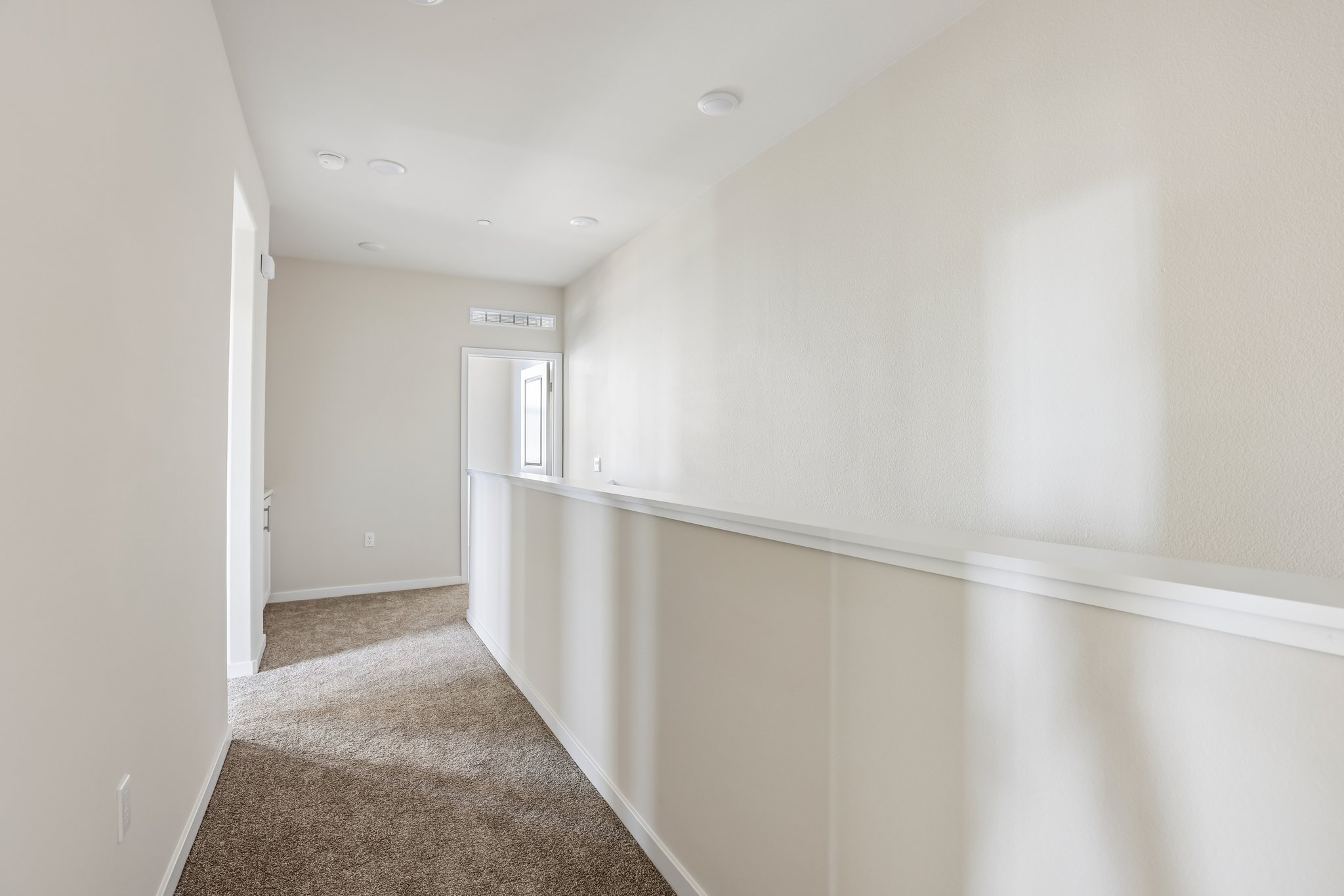 A hallway with white walls.