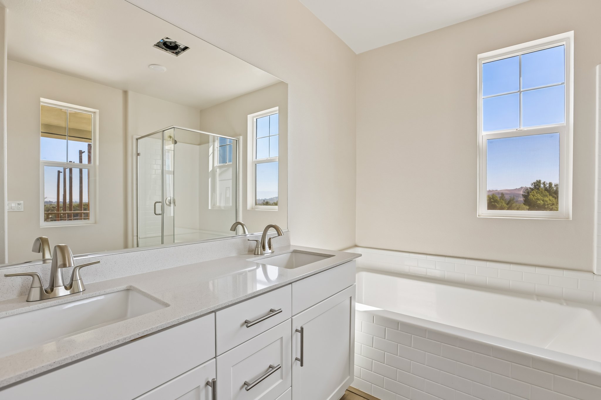 A bathroom with white cabinets.