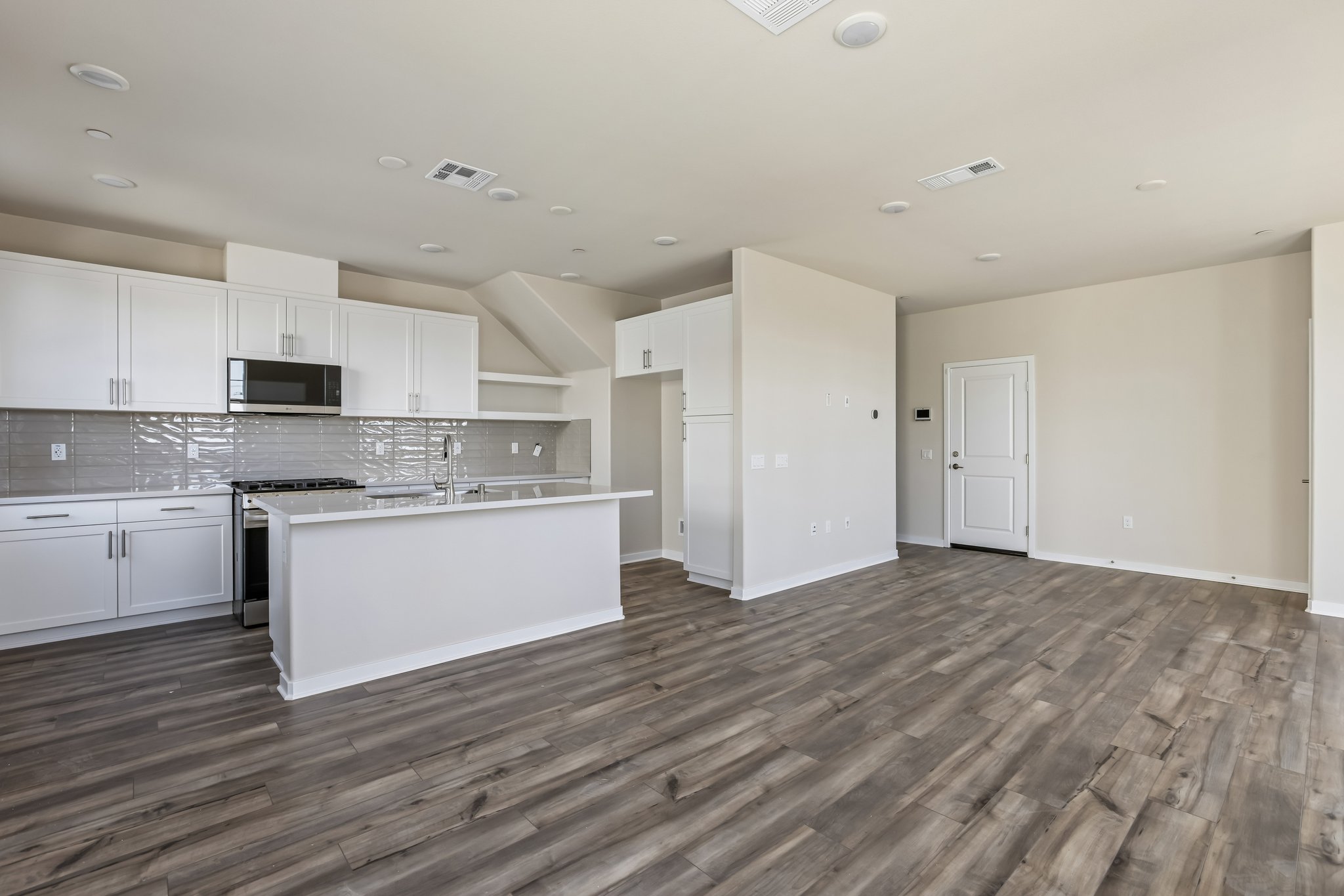 A large kitchen with white cabinets.