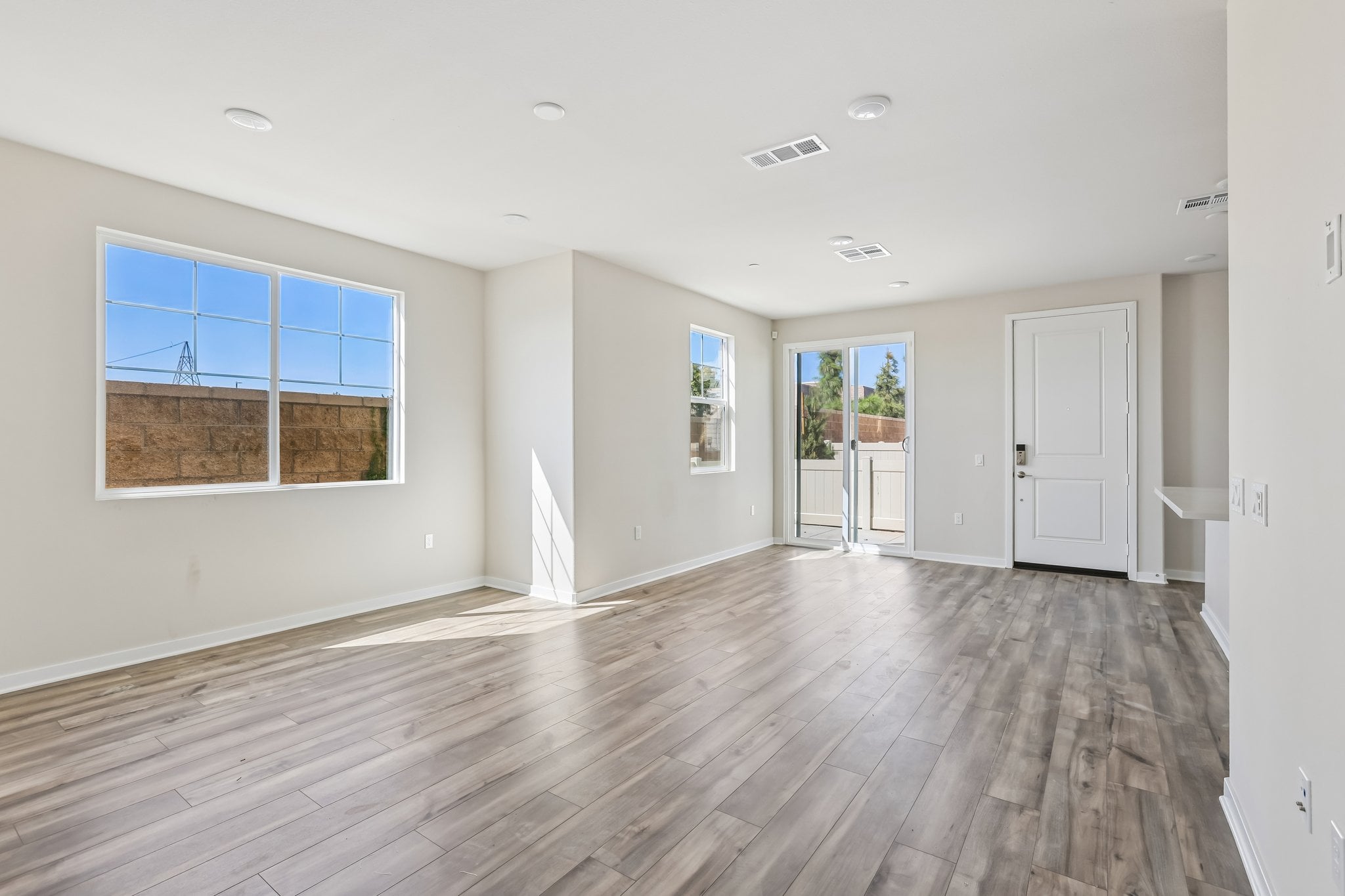 A large empty room with a wood floor and a wood floor.