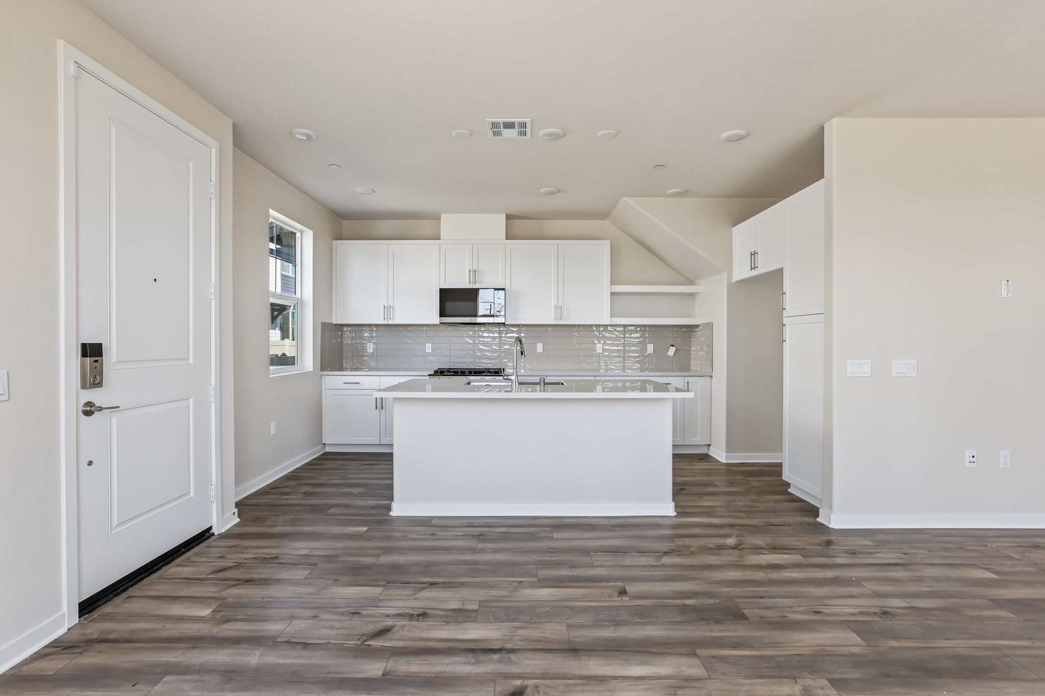 A kitchen with white cabinets.