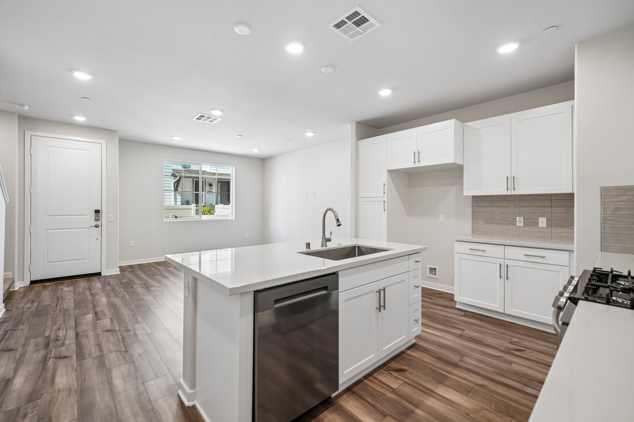 A kitchen with white cabinets.