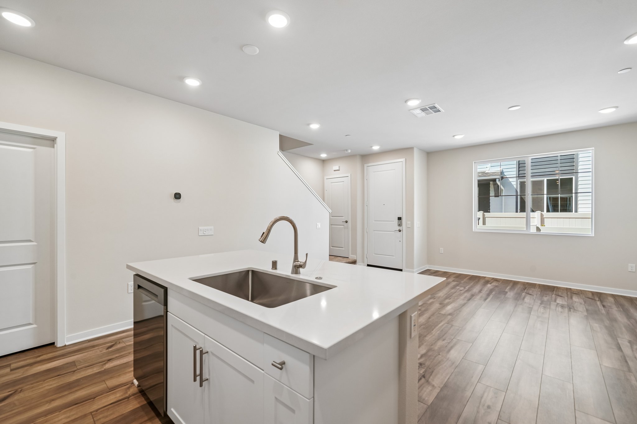 A kitchen with white cabinets.